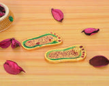 Lakshmi charan paduka footprints with green border and gold detailing, two angled pieces