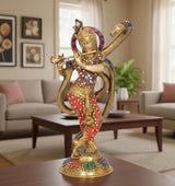 Brass Krishna sculpture playing flute, multicolored jewel-style detailing, standing pose.