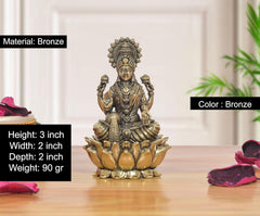 Bronze Lakshmi sitting statue with lotus base, ornate jewelry and raised hands, 3 inch.