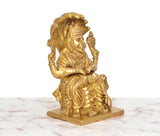 Brass Narasimha statue rear/side view, seated figure with shield and mace