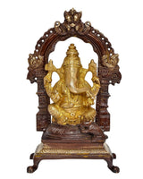 Seated Ganesh brass sculpture with decorative halo arch and detailed ornamental base