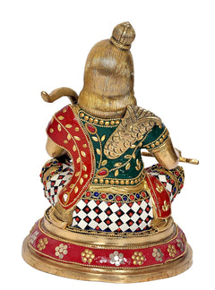 Back/angle Ram Lalla sitting brass idol with red drape and patterned ornament detailing