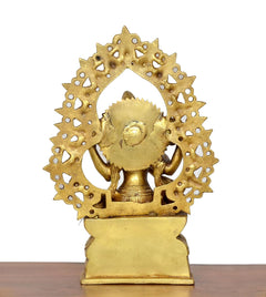 Brass Saraswati idol back view, circular halo with sculpted figures and pedestal