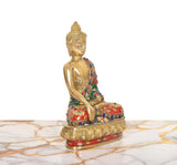 Brass Buddha statue side view, green and red decorated robe, ornate round base