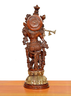 Krishna brass flute sculpture rear view with round shield motif and flared headdress