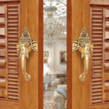 Brass Ganesha face door handle pair, ornate twin handles with curved lever grips