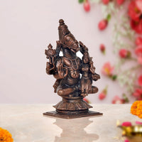 Copper Vishnu avatar statue angled view, seated multi-armed figure on square base