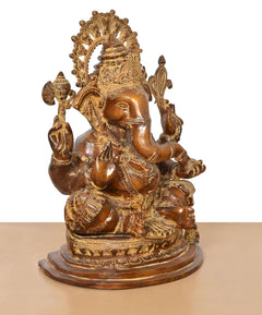 Brass Ganesha statue, brown, three-quarter view with detailed headpiece