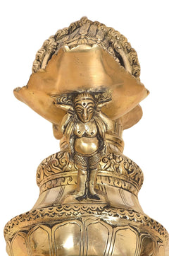 Brass oil lamp close-up of front deity face and ornate surrounding flame bowl