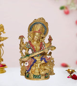 AONA brass Saraswati idol, seated goddess holding flute and bowl, jeweled colorful ornaments