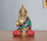 Meditating brass Buddha statue, green sash with red and blue bead garlands