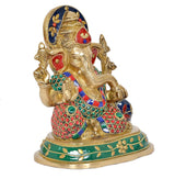 Brass Ganesha statue, three-quarter view with blue crown and green jeweled base