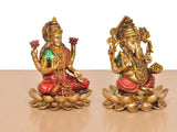 Resin Lakshmi and Ganesh statues sitting on lotus petals, angled side view