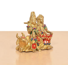 Brass Shiv family idol on nandi, colorful jewelry and decorative patterns