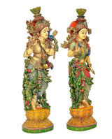 Radha-Krishna resin idol pair, facing figures with gold ornaments, red accents, and green robes