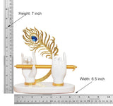 White resin Krishna hands with gold flute, blue peacock motif; 7 in height, 6.5 in width