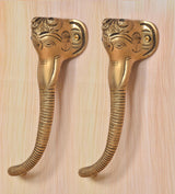 Brass Ganesha face door handle pair, gold finish, textured ridges on curved grips