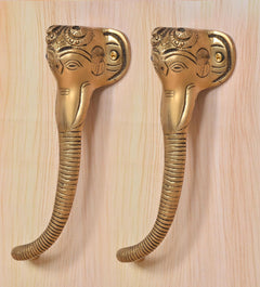 Brass Ganesha face door handle pair, gold finish, textured ridges on curved grips