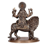 Durga seated on lion, back view; flared halo and flowing mane details