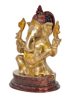 Brass Ganesha idol statue side view with crown details and red accents on base