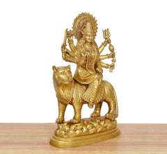 Brass Durga Maa idol on tiger base, angled view with ornate dress and hand-held trident