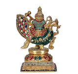 Saraswati brass idol from side view, jeweled disc swan seat, ornate painted patterns
