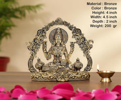 AONA bronze Lakshmi idol, 4 in tall, arch frame with kalash pots, seated on base