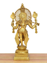 Rear view of gold Krishna sculpture playing flute, fluted halo and ornate back details