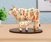 Resin Kamdhenu cow statue with calf figure, white base, colorful illustrated details
