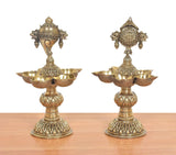 Pair of ornate brass shankh oil lamp stands with five diya cups and carved details