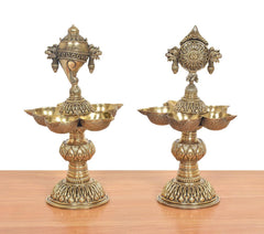 Pair of ornate brass shankh oil lamp stands with five diya cups and carved details