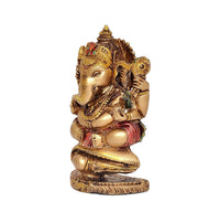 Resin Ganesha decorative figurine side view, gold finish with red-green detailing, round pedestal base