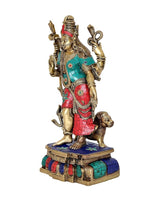 Side view brass Ardhnari statue with teal top and red skirt, standing on blue base