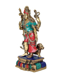 Side view brass Ardhnari statue with teal top and red skirt, standing on blue base