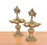 Angled view of brass five-diya shankh lamp stand with detailed pedestal and bowls