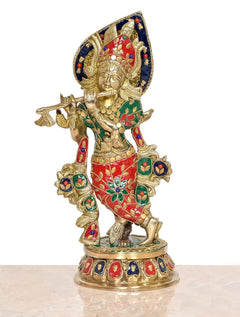 Brass Krishna playing flute idol statue, full view with blue halo and red-green patterned robe.