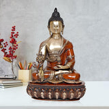 Brass Buddha statue idol with orange robe, seated on carved lotus base