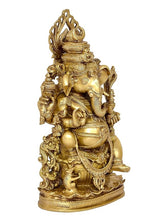 Back angle gold Ganesha idol with raised trunk, carved ornaments, and crown