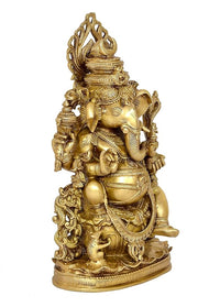 Back angle gold Ganesha idol with raised trunk, carved ornaments, and crown
