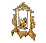 Brass Ganesha on swing with detailed side pillars and carved base, gold tone