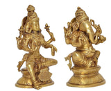 Brass Lakshmi and Ganesha statue, angled view showing seated posture and jewelry details