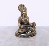 Brass Maa Annapurna murti, angled view seated with raised right hand and ornaments