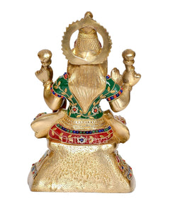 Back view of brass Lakshmi statue with arched halo and detailed multicolor bodice