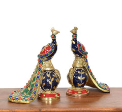 Close view brass peacock figurines with dark blue body, gold scales, multicolor trim