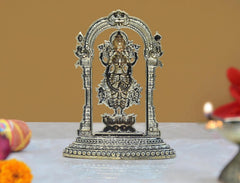 Brass Lakshmi statue figurine with ornate back arch and lotus base