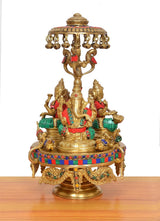 Brass Lakshmi-Ganesha-Saraswati idol with parasol canopy and jeweled rim, multicolor