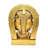 Close-up of golden brass back of Vishnu Dasavatara idol with arched frame