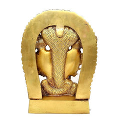 Close-up of golden brass back of Vishnu Dasavatara idol with arched frame