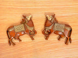 Brass Kamdhenu cow pair wall hanging with detailed carved heads and patterned saddles