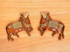 Brass Kamdhenu cow pair wall hanging with detailed carved heads and patterned saddles